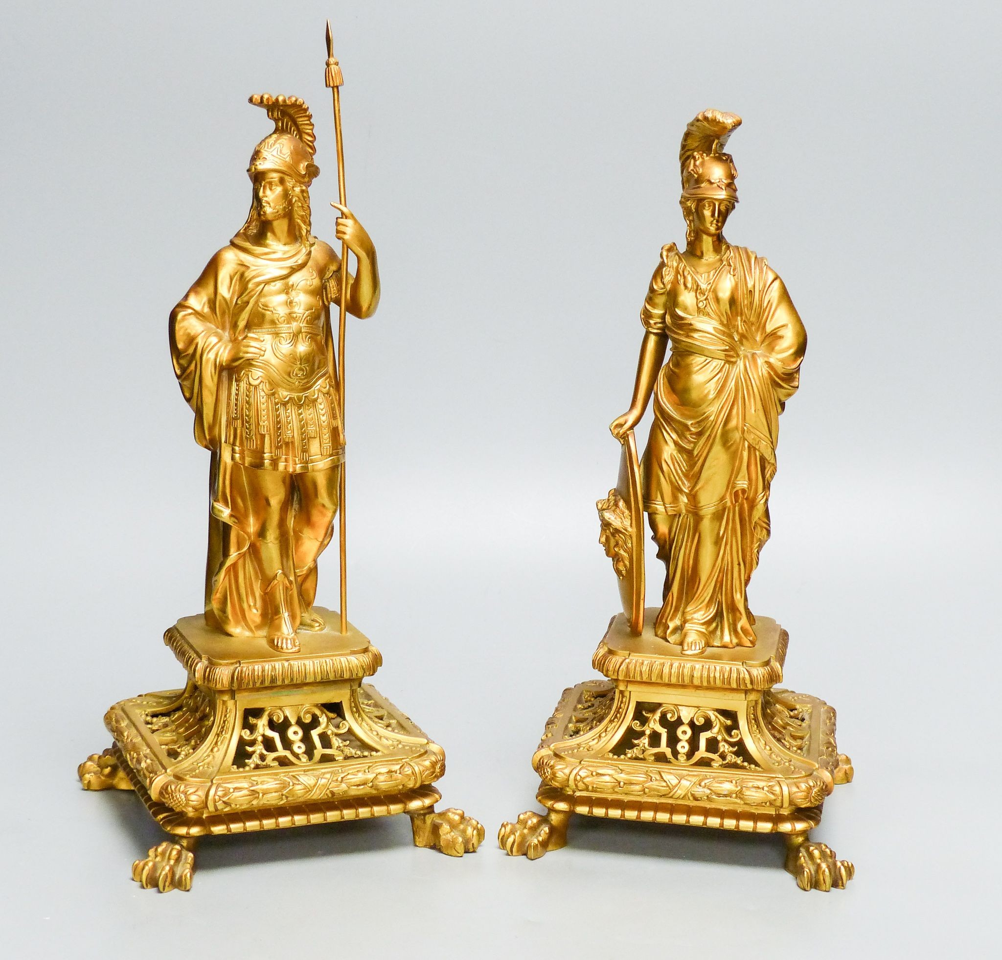 A pair of late 19th century ormolu figures of Roman soldiers, on openwork faces, tallest 32.5 cm